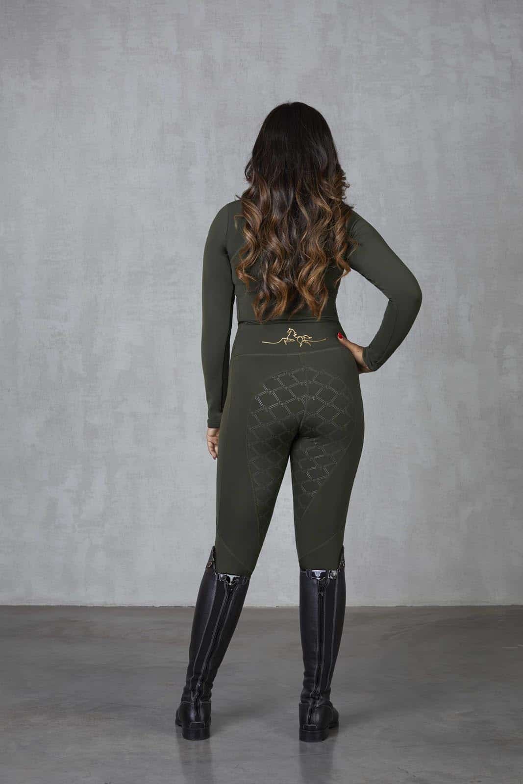 A brunette model wearing our long sleeved fleece lined khaki base layer with matching khaki leggings.