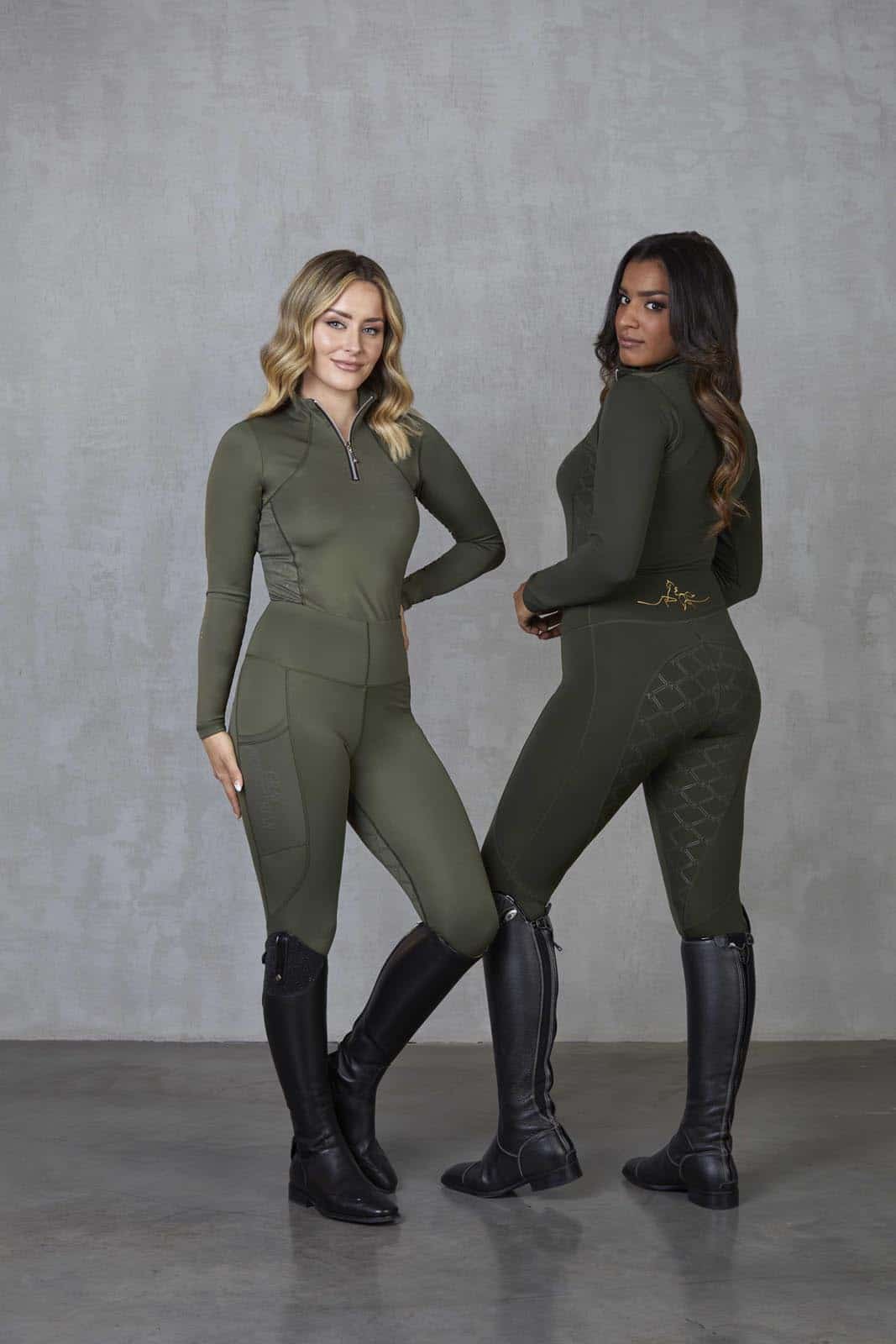 Two models standing side by side. The model on the left is wearing our fleece lined khaki base layer and matching riding leggings. The model on the right is wearing our green base layer and leggings.