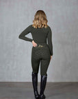 A blonde model wearing our fleece lined long sleeve khaki base layer and matching khaki riding leggings.