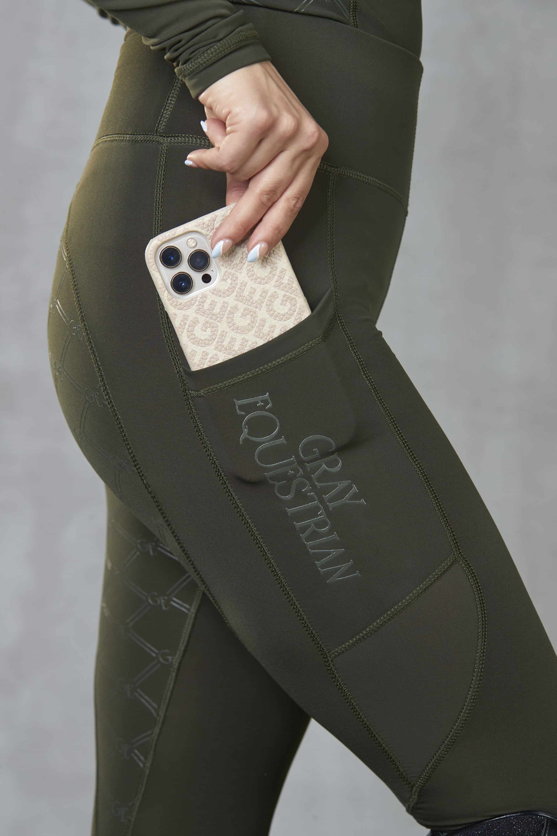A view of the side of our leggings with it&#39;s phone pocket and subtle Gray Equestrian branding.