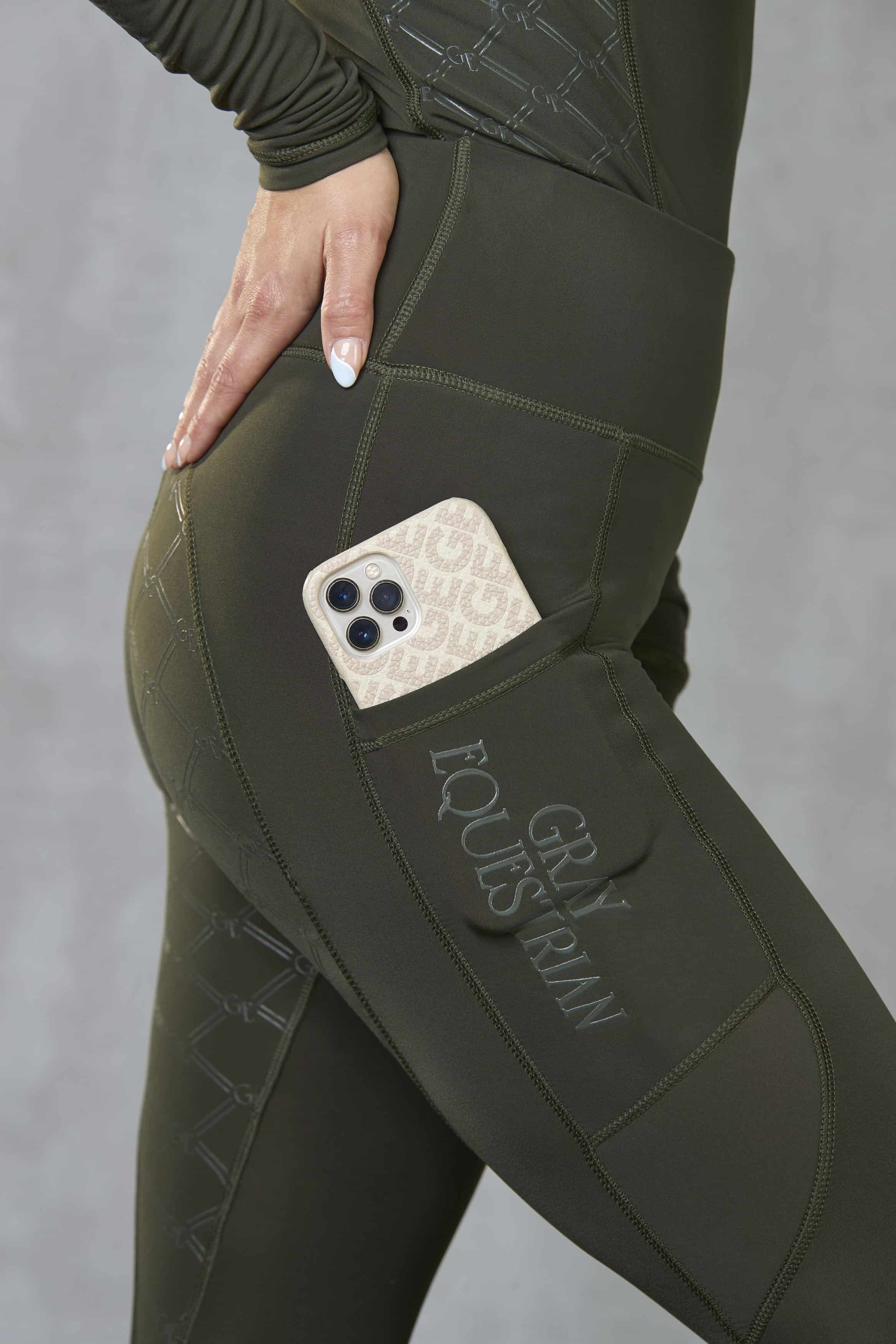 A view of the side of our leggings with it&#39;s phone pocket and subtle Gray Equestrian branding.