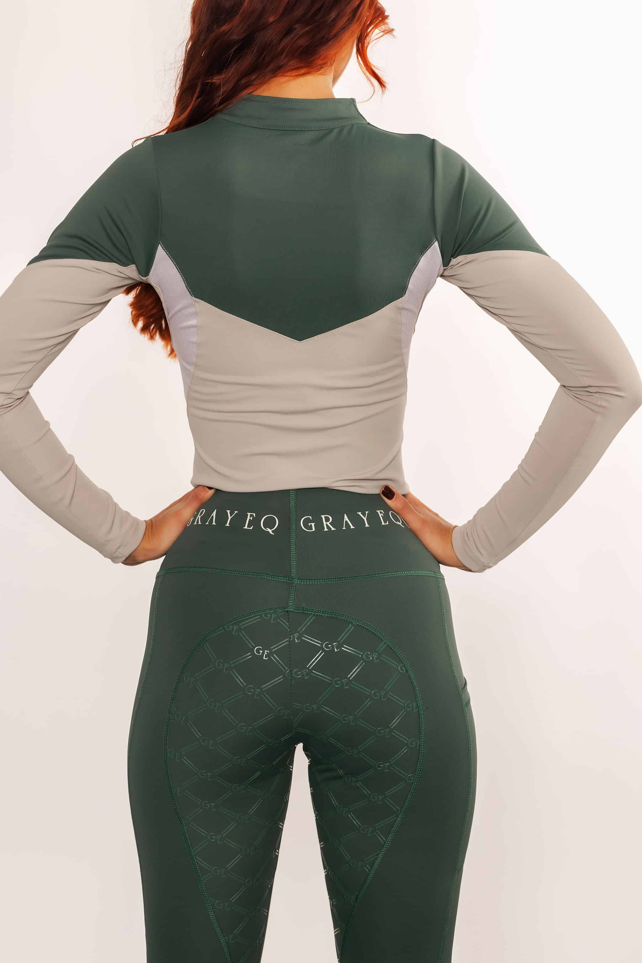 A view of the back of our green riding leggings with full non slip seat.