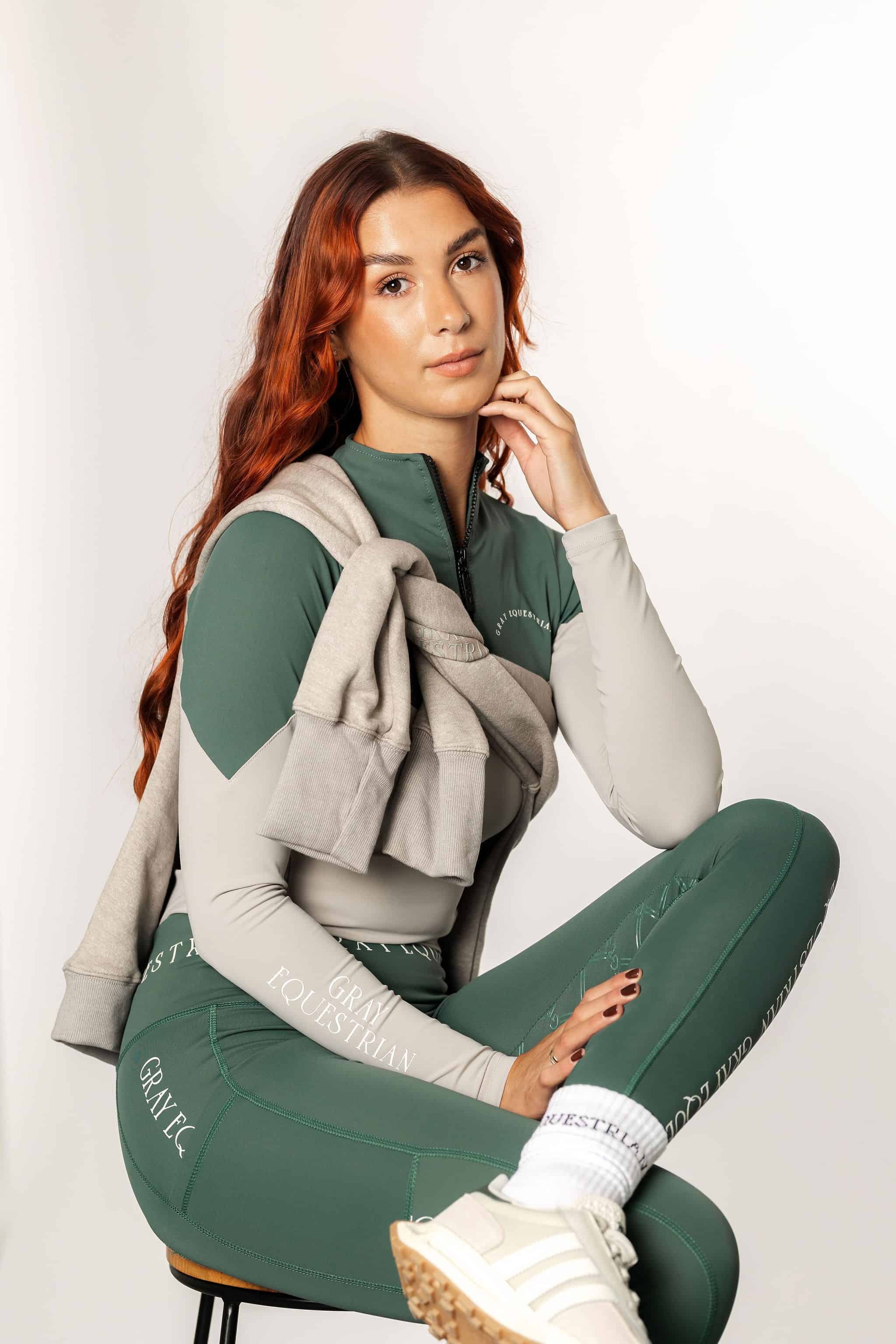 A model wearing our green and grey two toned base layer and matching green riding leggings.