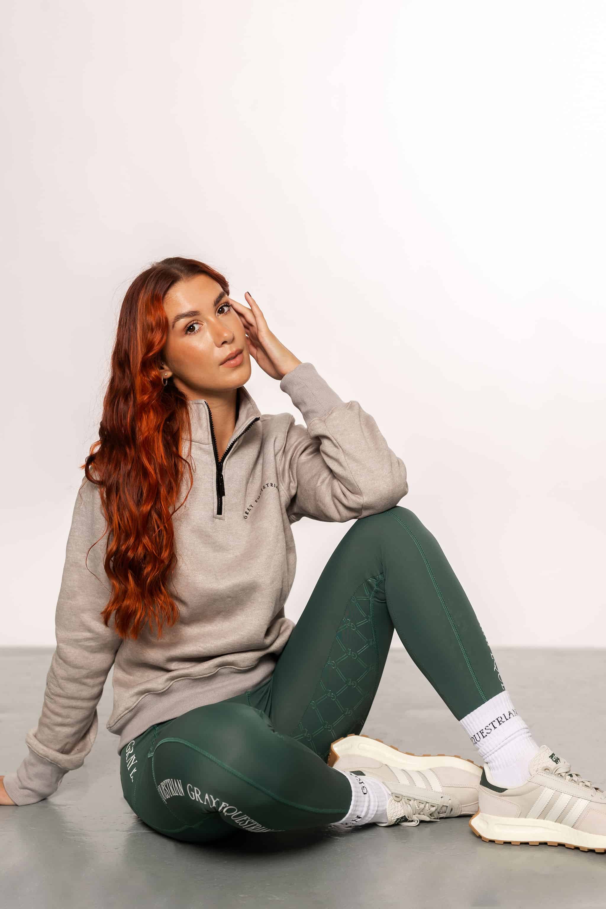 A model wearing our green and grey two toned base layer and matching green riding leggings.