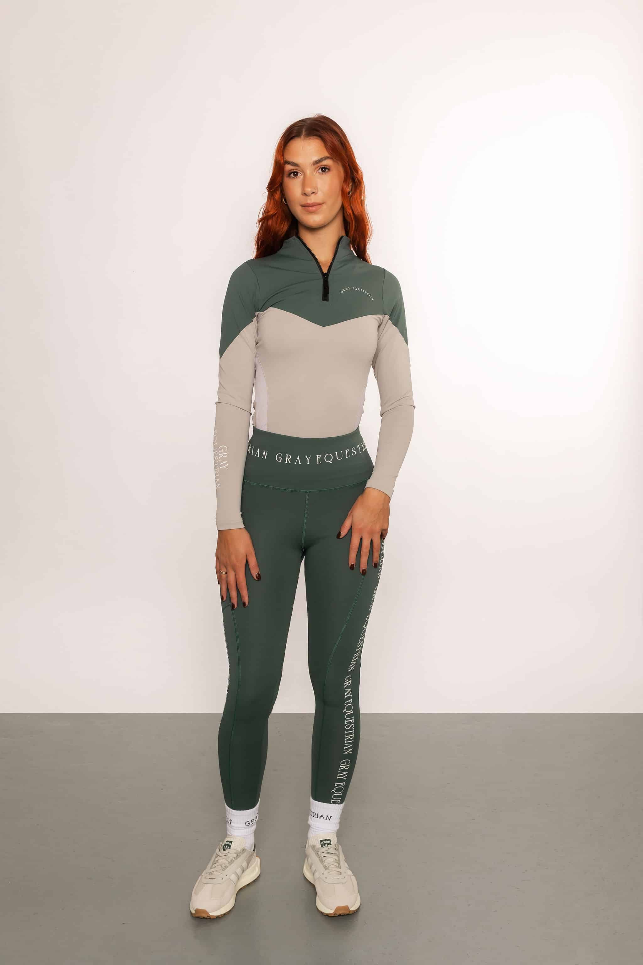A model wearing our green and grey two toned base layer and matching green riding leggings.