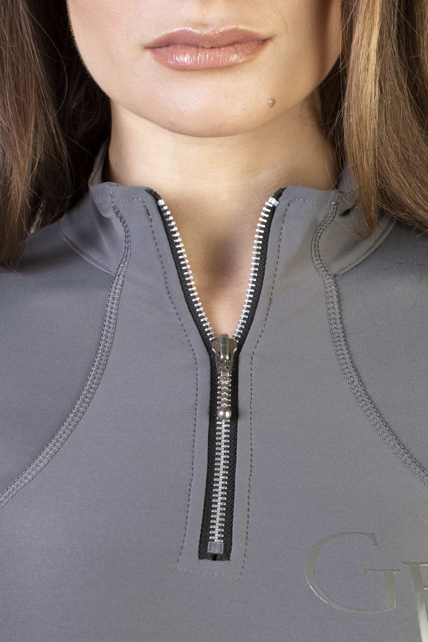 A close up of the silver 1/4 zip.