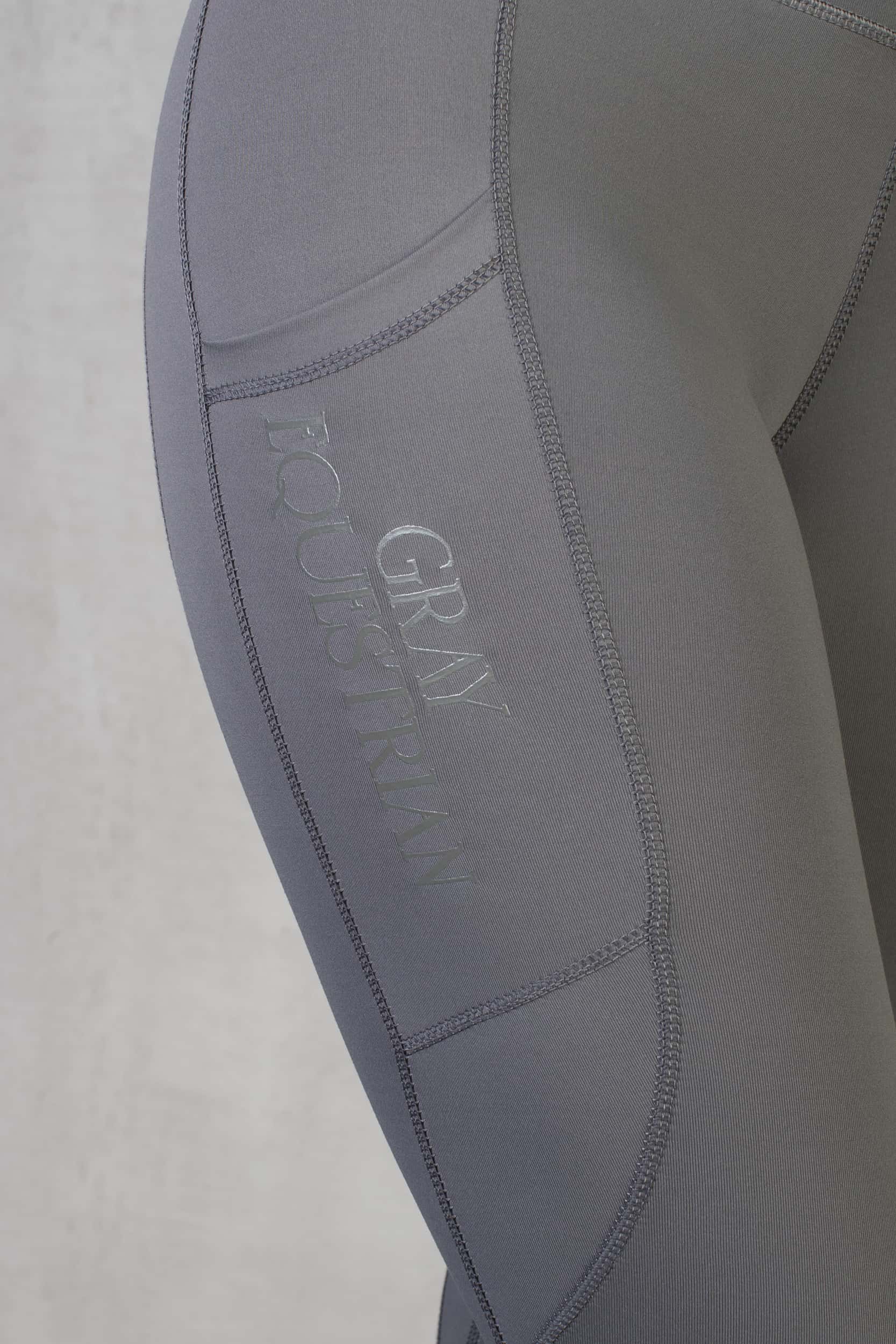 A view of the phone pocket on the side of our grey leggings.