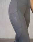 A view of the side of our grey riding leggings with phone pocket.