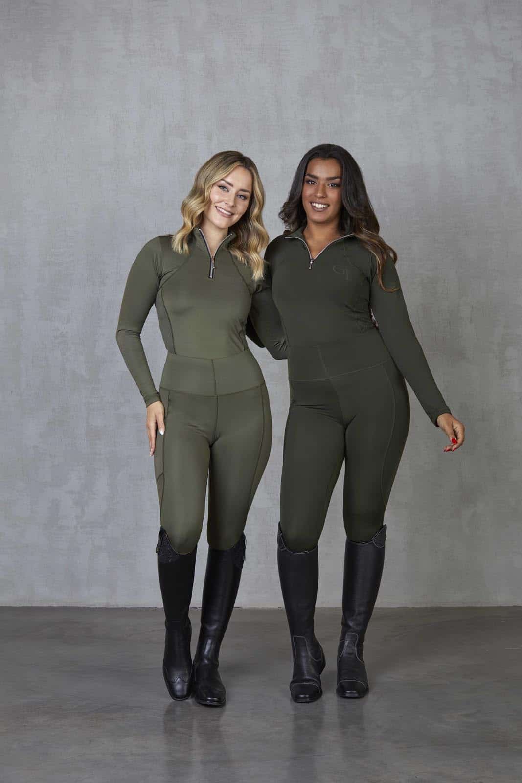 Two models standing side by side. The model on the left is wearing our khaki base layer and leggings. The model on the right is wearing our green base layer and leggings.