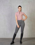 A model wearing our light pink base layer and grey riding leggings.