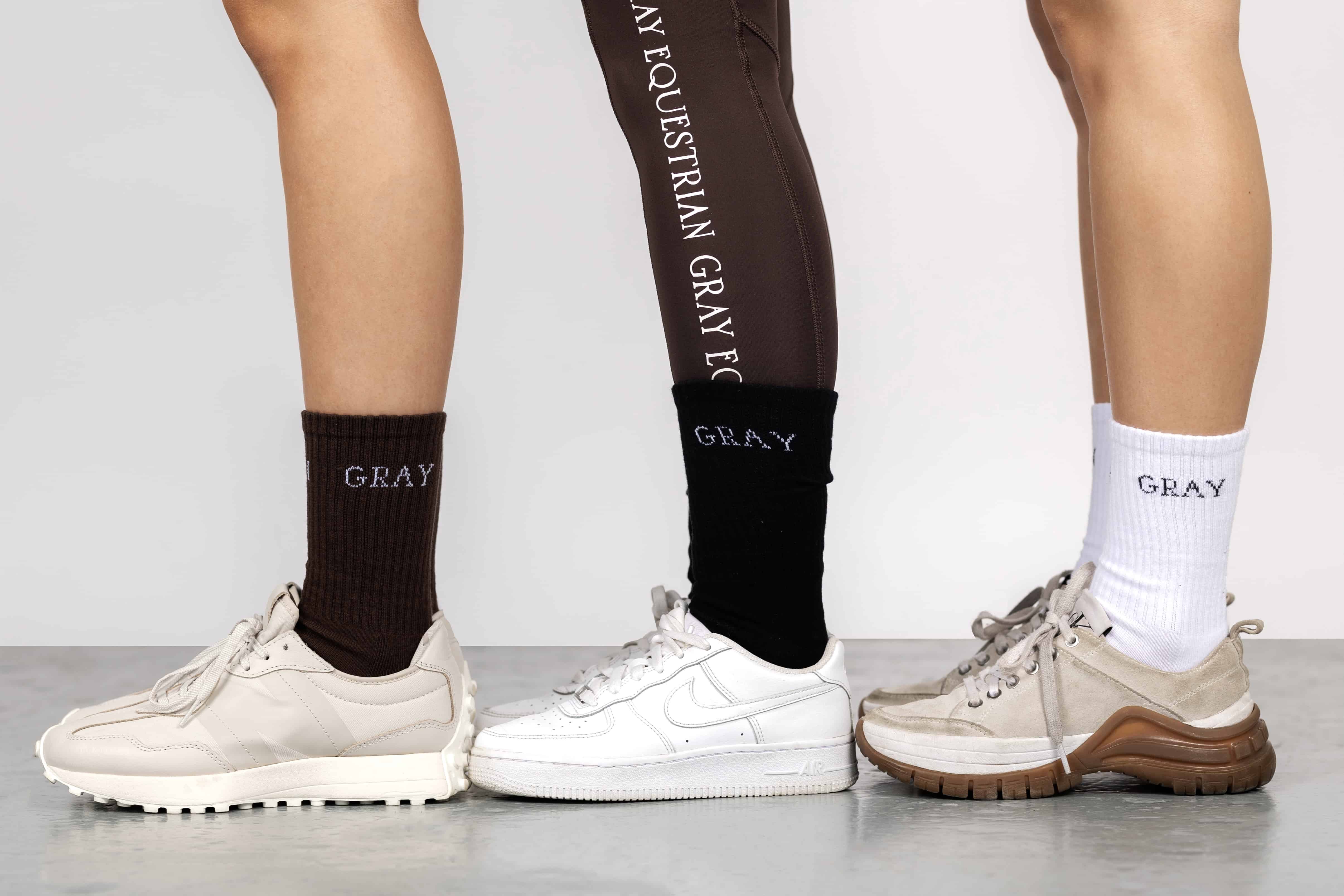 Three models wearing our brown, black and white renew socks.