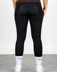 A view of the back of our black renew leggings with full non slip seat.