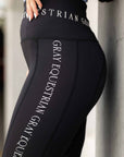A close up of our black renew riding leggings with white Grey Equestrian branding down the side and on the waist band.
