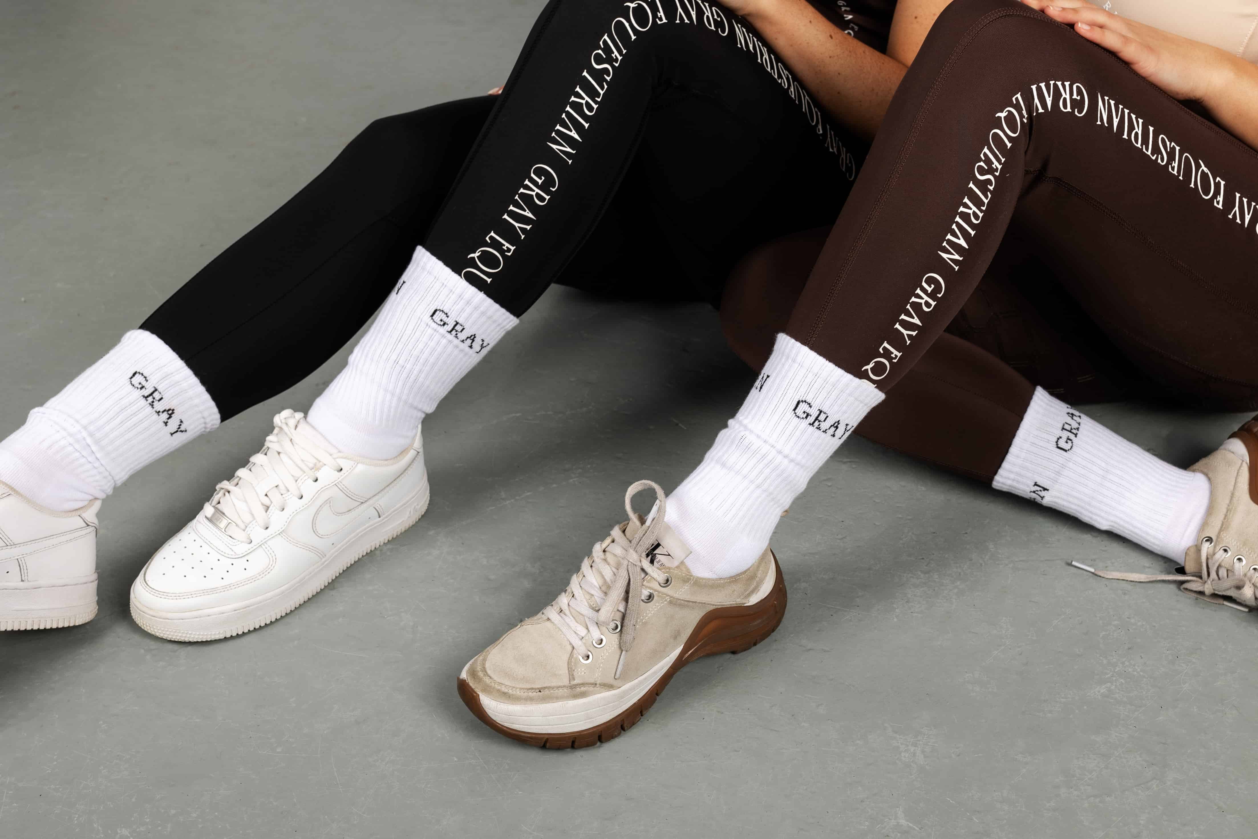 Two models wearing our riding leggings with white Grey Equestrian socks.