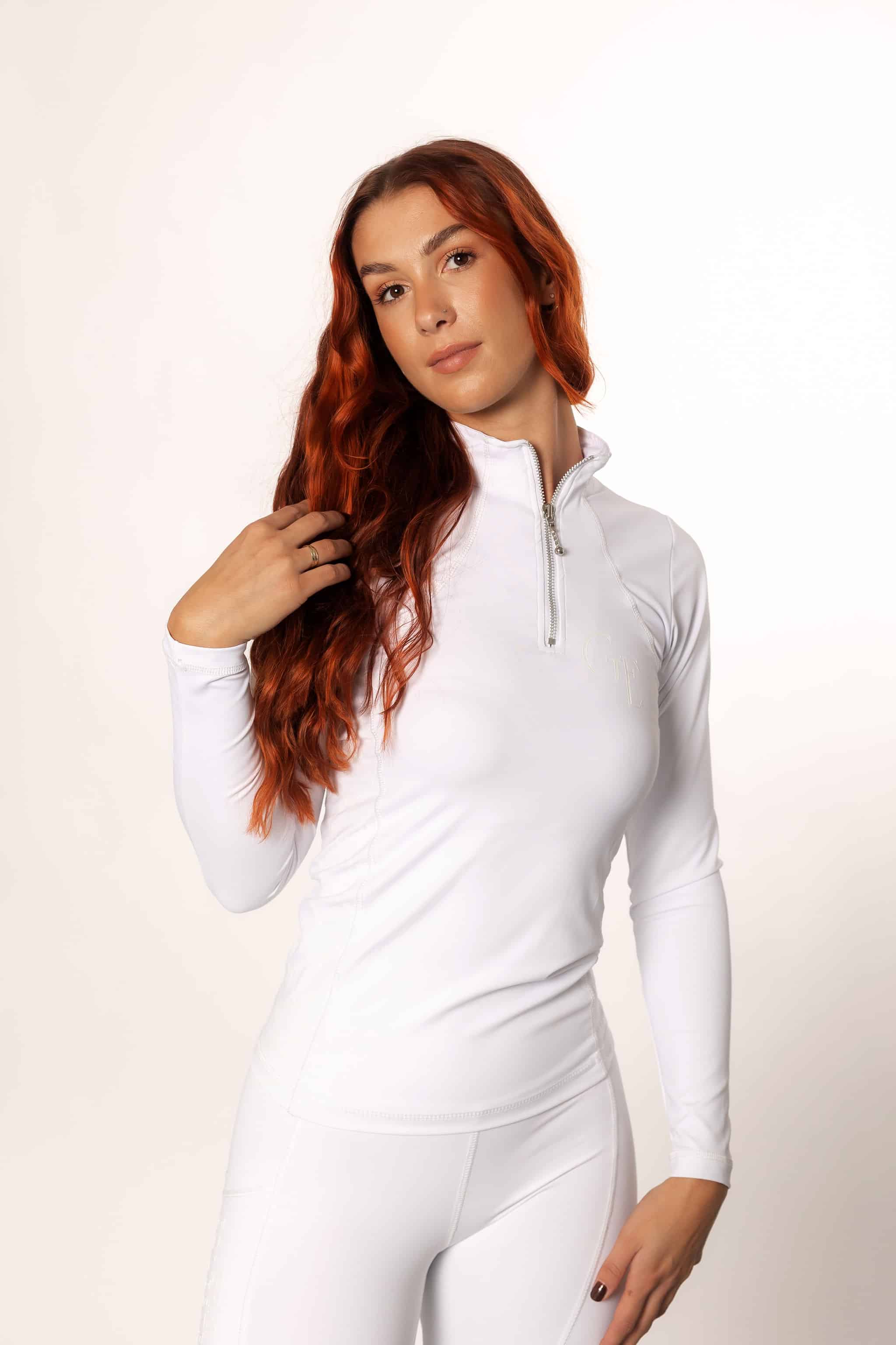 A model wearing our white long sleeved base layer and matching riding leggings.