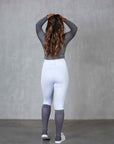 A model wearing our white competition leggings.